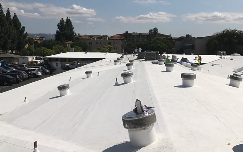 Photo of a TPO roof on a commercial building in New Jersey in the process of being installed by Everest Construction Group.