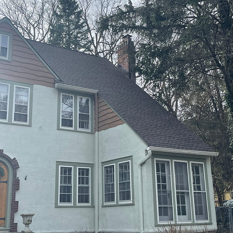 Photo of a roof recently replaced on a tudor-style home with GAF Barkwood HDZ shingles by Everest Construction Group