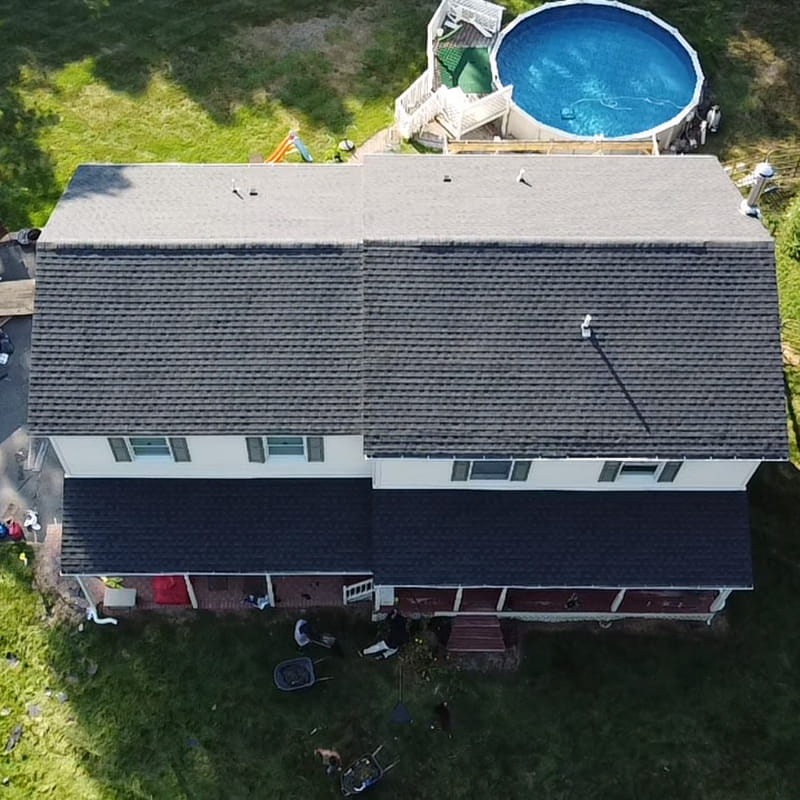 Aerial photo of finished roof with GAF Charcoal HDZ shingles, done by Everest Construction Group