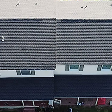 Aerial view of a home with a newly completed roof done by Everest Construction Group , with GAF Charcoal HDZ shingles