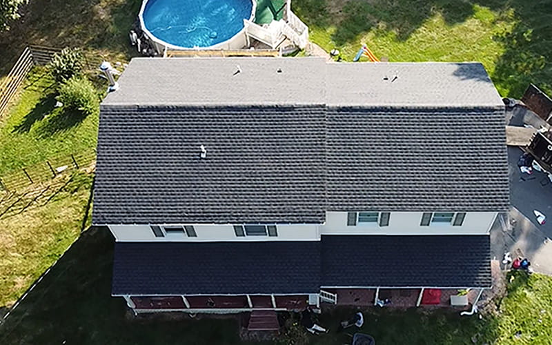 Aerial view of a home with a newly completed roof done by Everest Construction Group , with GAF Charcoal HDZ shingles