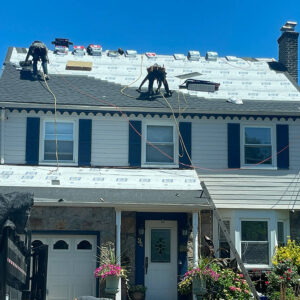 Photo of Everest Construction Group team members working on a roof replacement